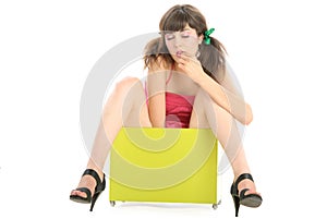 Beautiful young woman sits in box