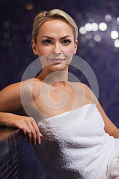 Beautiful young woman sitting in bath towel
