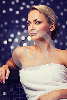 Beautiful young woman sitting in bath towel