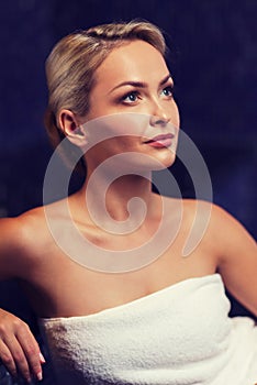 Beautiful young woman sitting in bath towel