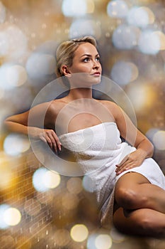 Beautiful young woman sitting in bath towel