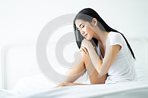 Beautiful young woman sitting sleeping over white backgroung in