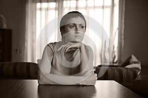 Beautiful young woman sitting at the table