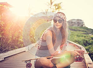 Beautiful young woman with a skateboard
