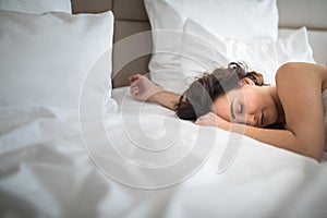Beautiful young woman sleeping on bed