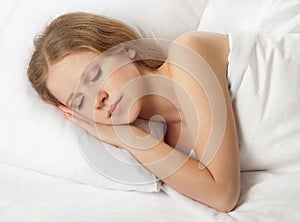 Beautiful young woman sleeping in bed