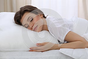 Beautiful young woman sleeping while lying in her bed. Concept of pleasant and rest reinstatement for active life