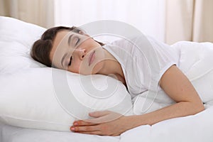 Beautiful young woman sleeping while lying in her bed. Concept of pleasant and rest reinstatement for active life