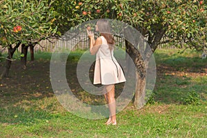 Beautiful young woman smelling organic apple