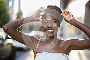 Beautiful young woman smiling in the city