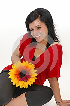 Beautiful young woman smiling with flower and butterfly