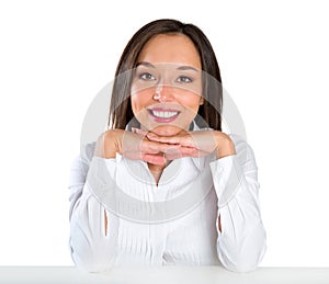 Beautiful young woman smiling sitting by table.