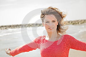 Beautiful young woman smiling on a windy day