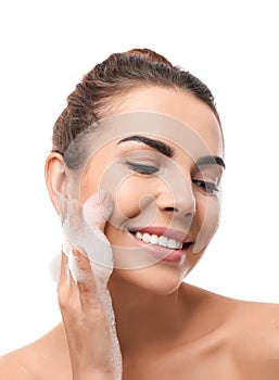 Beautiful young woman with soap foam on white background