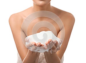 Beautiful young woman with soap foam on white background