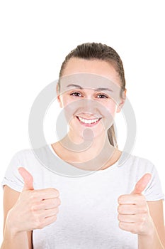 Beautiful young woman in sports wear showing thumbs up, looking at camera and smiling isolated over white background