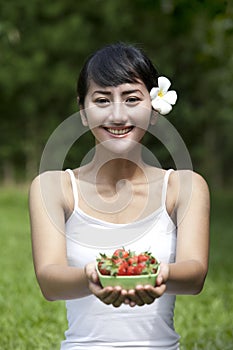 Beautiful young woman with strawberry