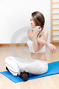 beautiful young woman stretching the muscles of her in yoga class