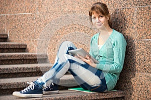 Beautiful young woman student with note pad