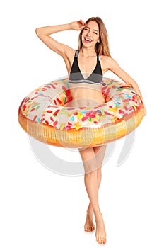 Beautiful young woman in stylish bikini with doughnut inflatable ring