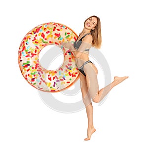 Beautiful young woman in stylish bikini with doughnut inflatable ring