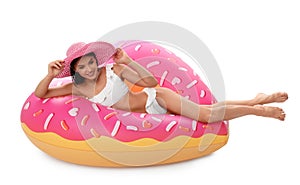 Beautiful young woman in stylish bikini with  and inflatable ring on white background