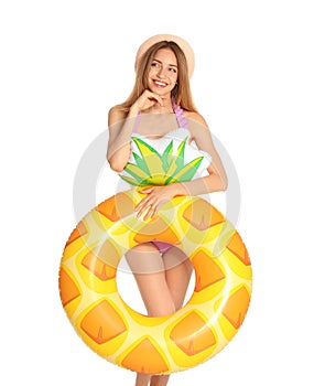 Beautiful young woman in stylish bikini with pineapple inflatable ring on white