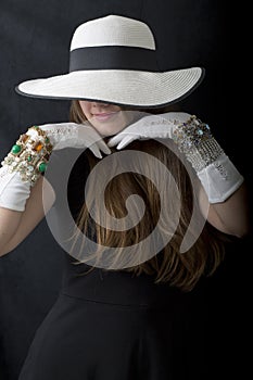 Beautiful Young Woman with Stylish Floppy Hat, Long Vintage White Gloves and Jewelry