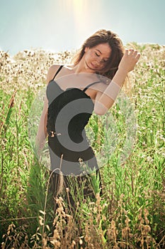 Beautiful young woman in summer field