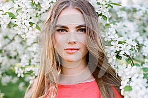 Beautiful young woman in summer garden photo