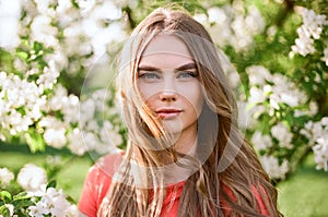 Beautiful young woman in summer garden photo