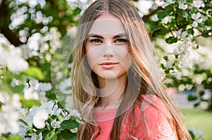 Beautiful young woman in summer garden photo