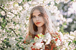 Beautiful young woman in summer garden photo