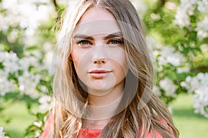 Beautiful young woman in summer garden photo