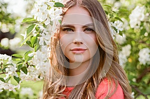 Beautiful young woman in summer garden photo