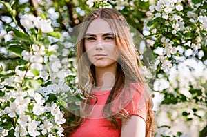 Beautiful young woman in summer garden photo