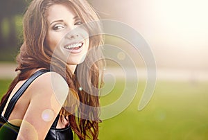 Beautiful young woman in summer park.