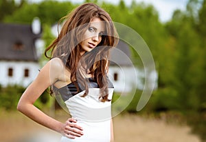 Beautiful young woman in summer park.