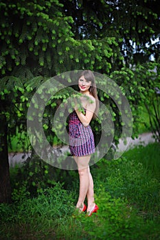 Beautiful young woman in a summer park outdoor portrait close up