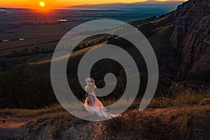 Beautiful young woman at sunset