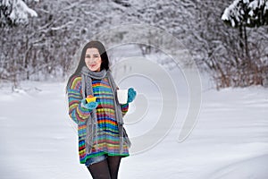 Beautiful young woman in a sweater. Winter outdoors walk with a