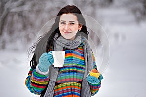 Beautiful young woman in a sweater. Winter outdoors walk with a