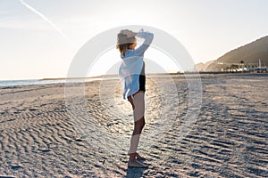 Beautiful young woman in swimsuit on beach