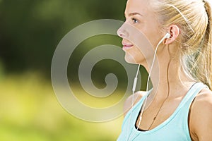 Beautiful young woman taking break after workout