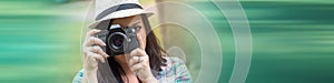 Beautiful young woman taking pictures in a park