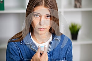 Beautiful young woman taking pill at home