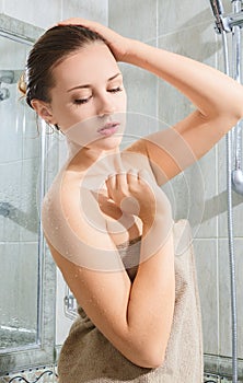 Beautiful young woman taking shower