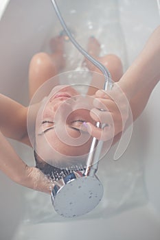 Beautiful young woman taking a shower