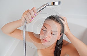 Beautiful young woman taking a shower