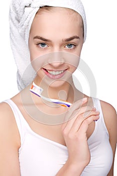 Beautiful young woman with toothbrush in her hands photo